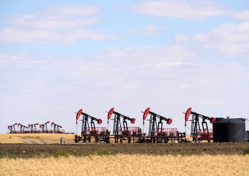 Oil settles slightly up on weaker dollar, US economic fears cap gains